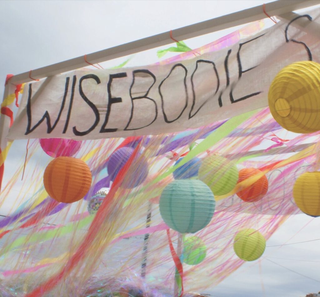Wisebodies Banner with lanterns and streamers of various colors. 