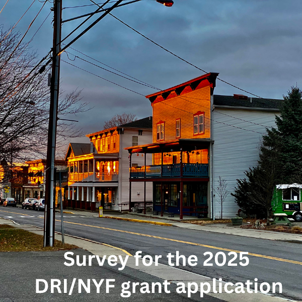 Night-time street view of building facades, red from a sunset.